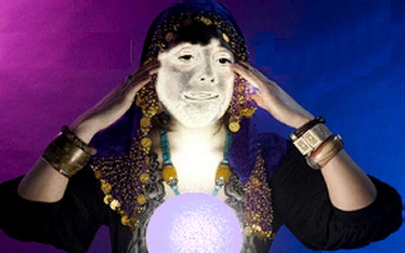 Costumed female fortune teller with crystal ball